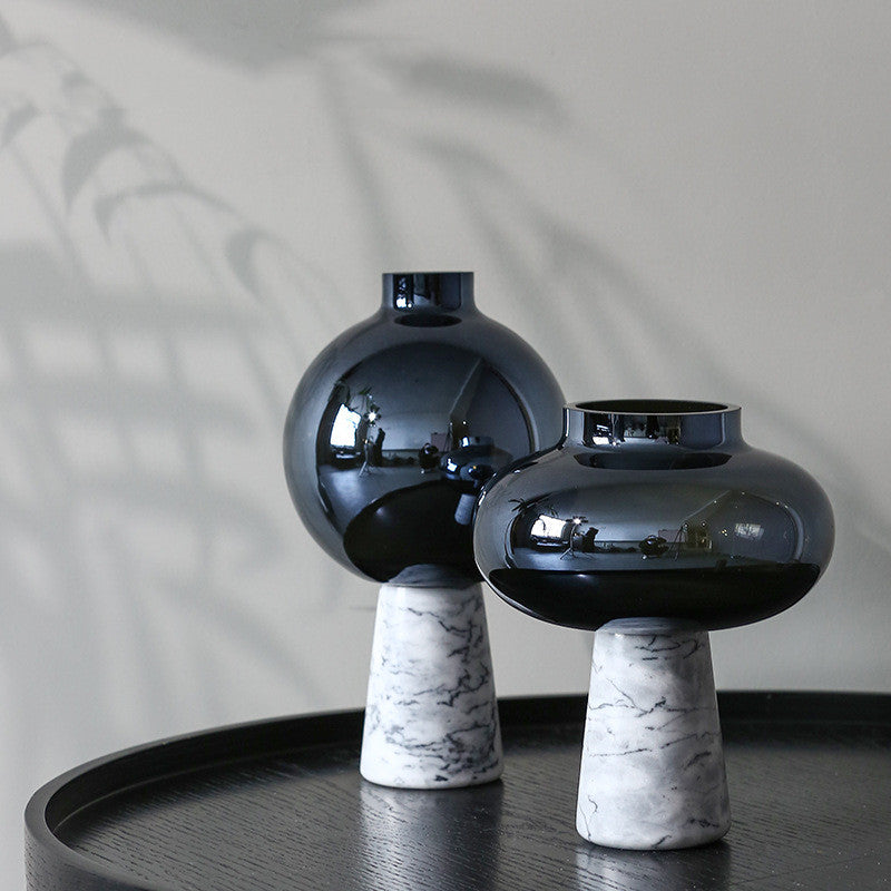 Black glass and marble vases on table