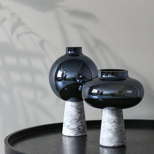 Black glass and marble vases on table
