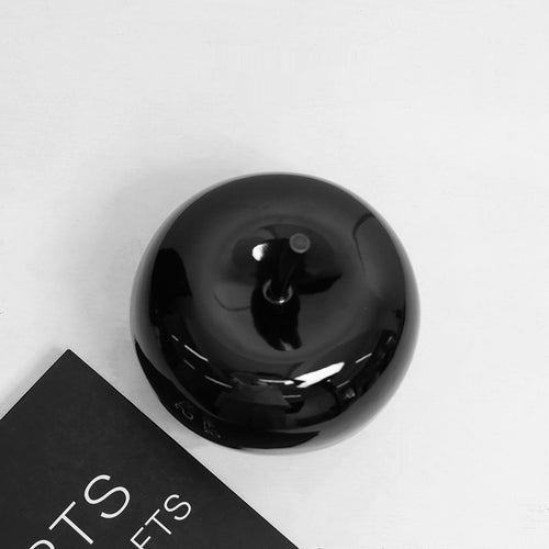 Top view of black ceramic apple showing stem detail
