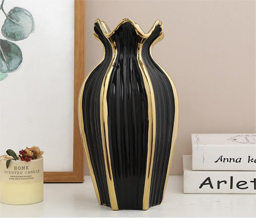 Front view of black and gold fluted ceramic vase