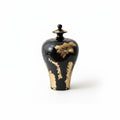 Large black ceramic temple jar with gold accents front view