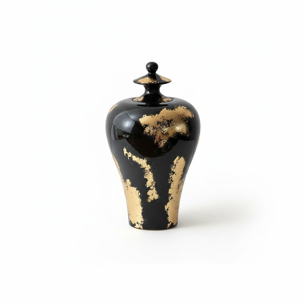 Large black ceramic temple jar with gold accents front view