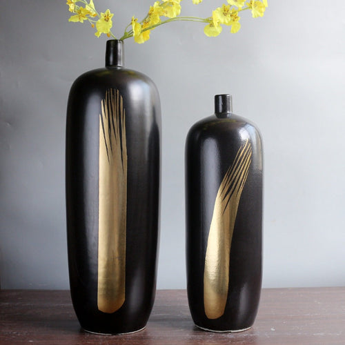 Black ceramic vase set with gold brushstroke detail with yellow flowers