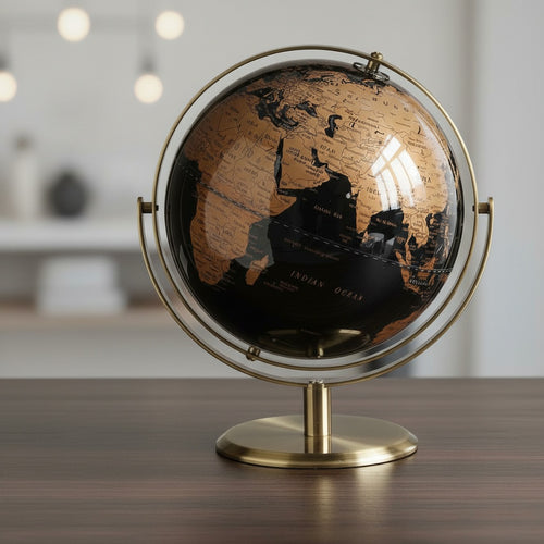 Front view of black and gold desktop globe on wooden surface
