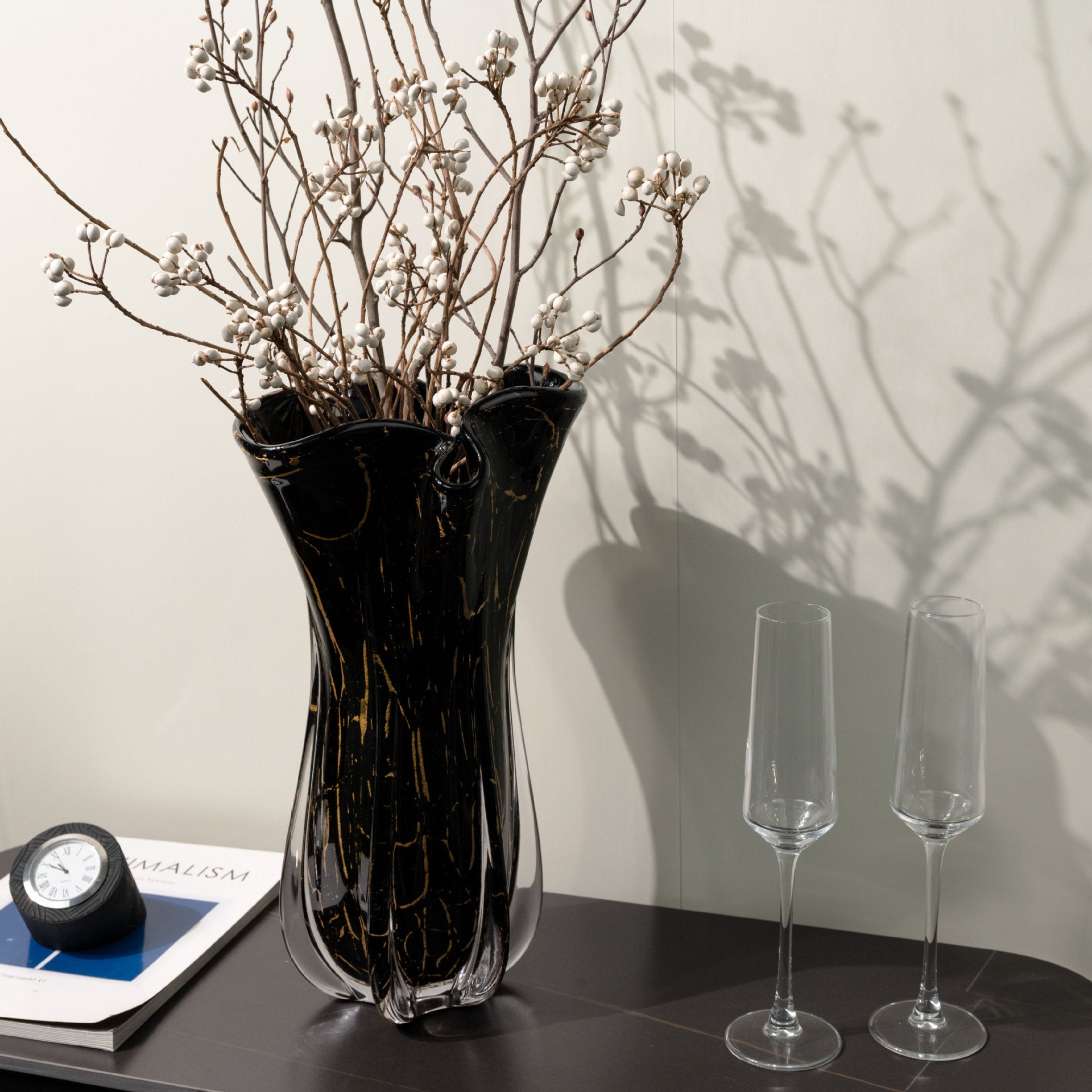 Large black glass wavy vase with gold veining and dried branches