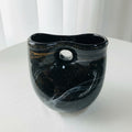 Front view of black and gold sculptural glass vase
