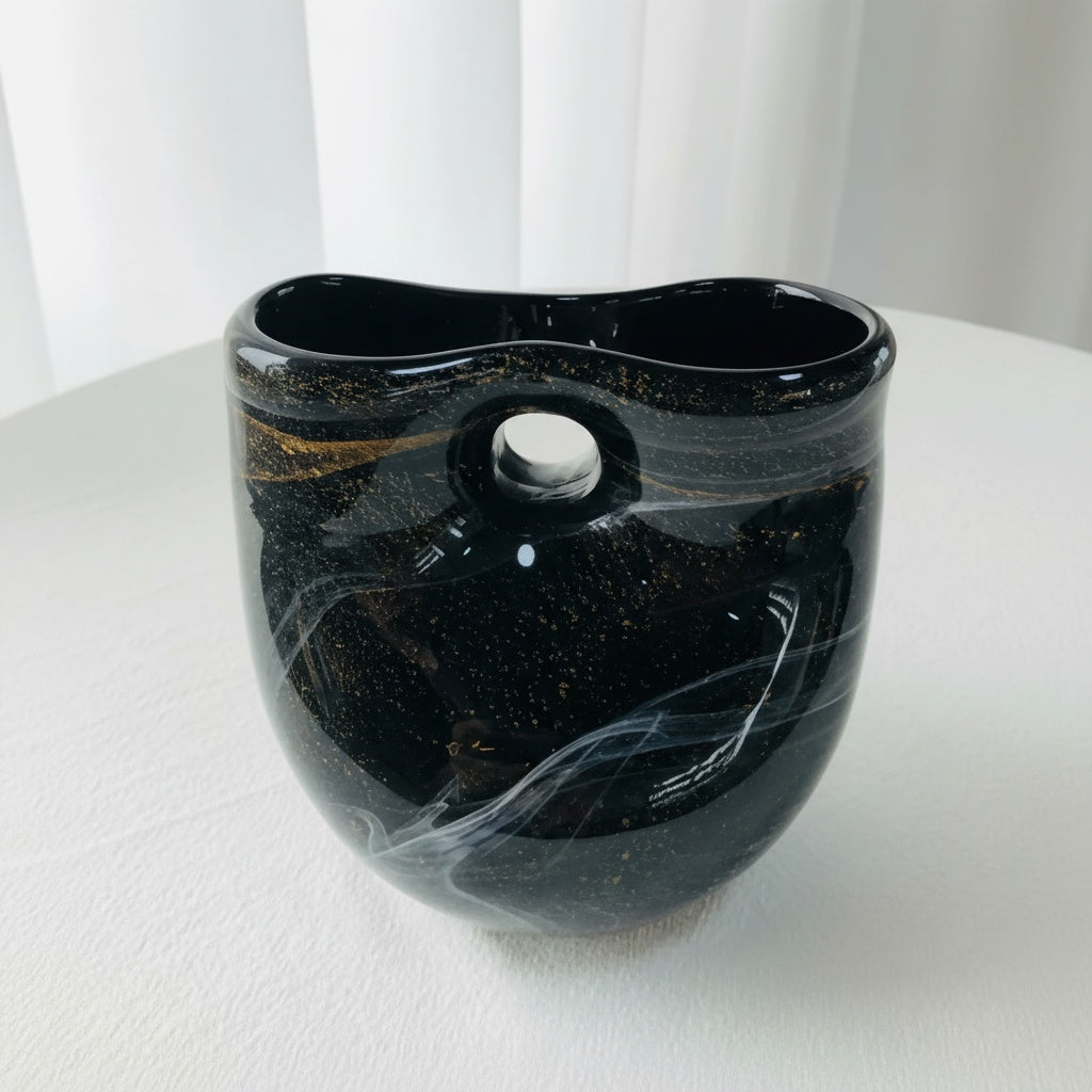 Front view of black and gold sculptural glass vase