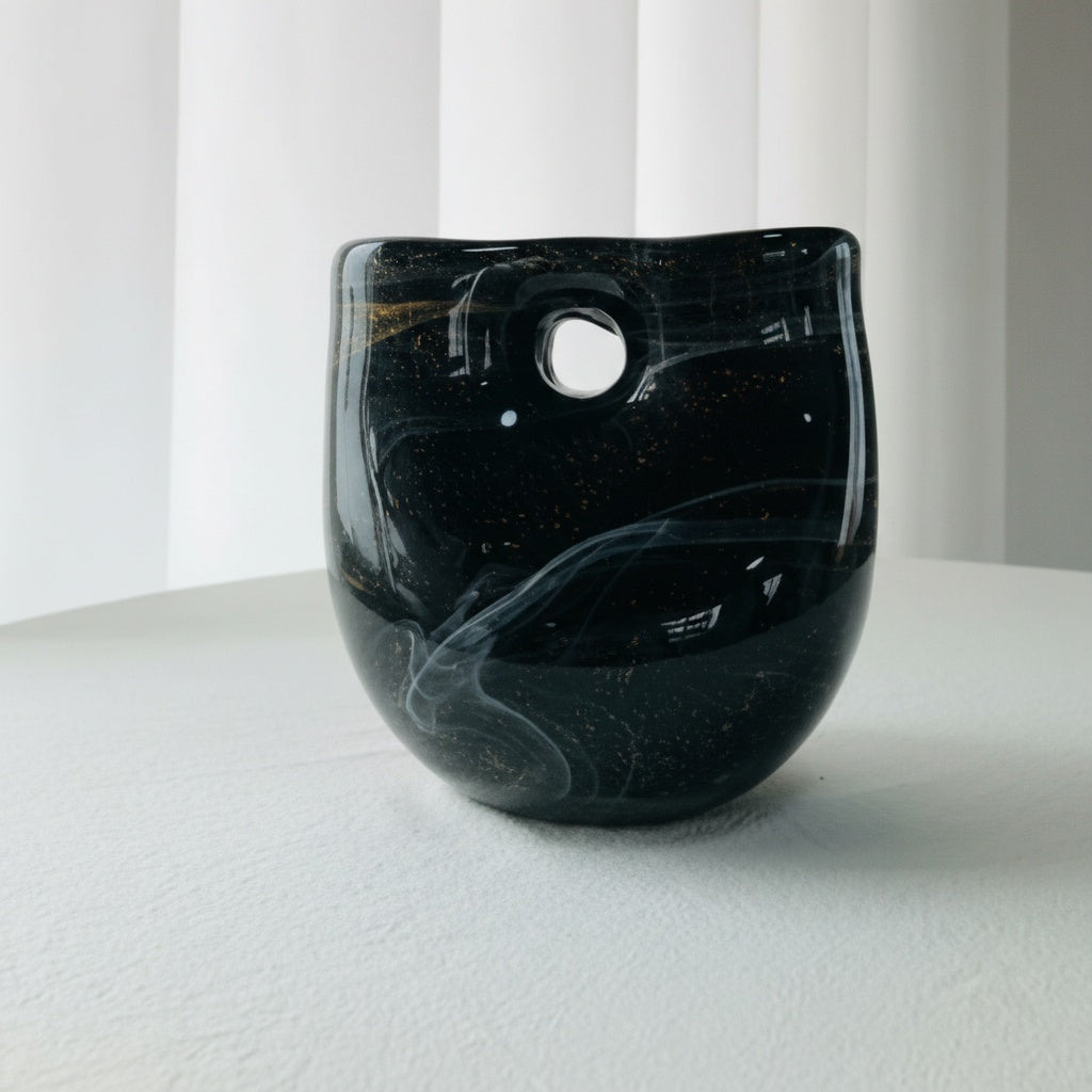 Detail of black glass vase with gold flecks