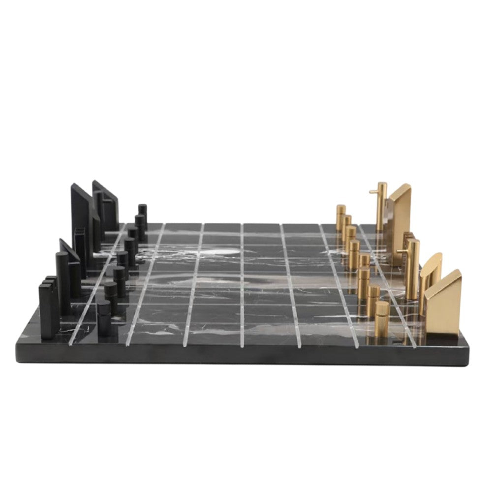 Low side view of minimalist black marble and brass chess set