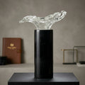 Black marble cylindrical base with a clear fluid glass top decorative sculpture
