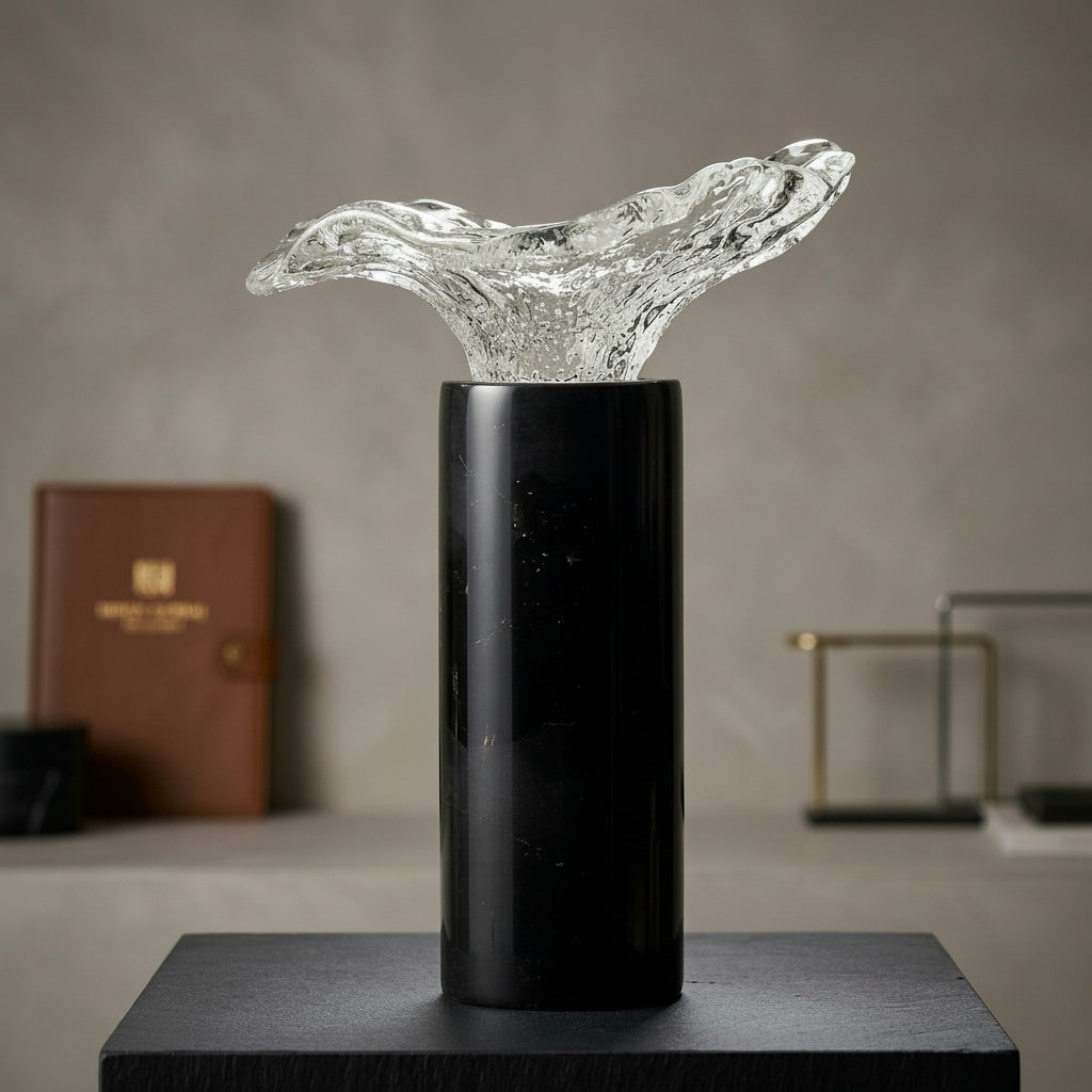 Black marble cylindrical base with a clear fluid glass top decorative sculpture