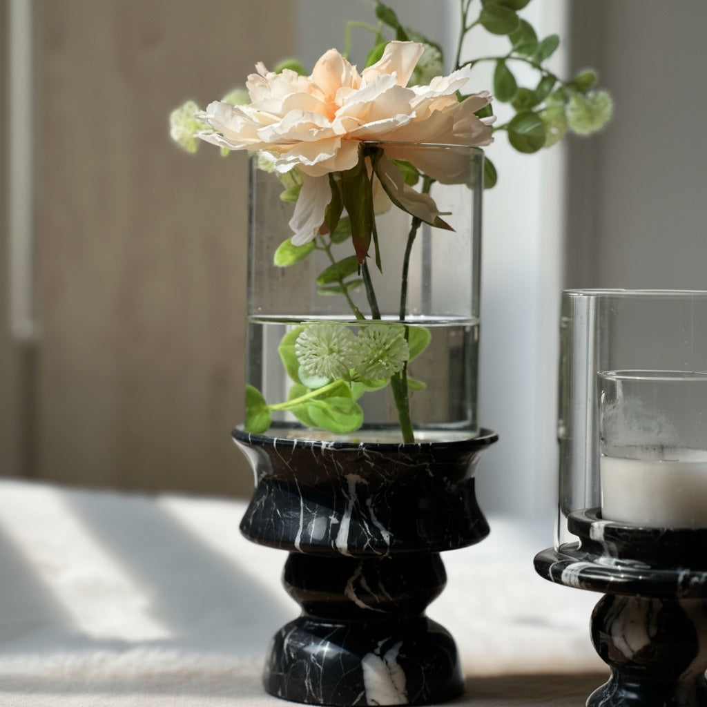 Black marble base vase with flowers on window sill