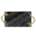 Flat lay of black marble tray with white veining and ornate gold metal handles