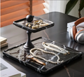 High angle view of black marble jewelry stand holding pearls and accessories