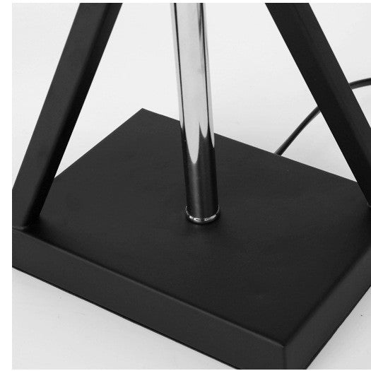 Detail of black rectangular base and chrome pole