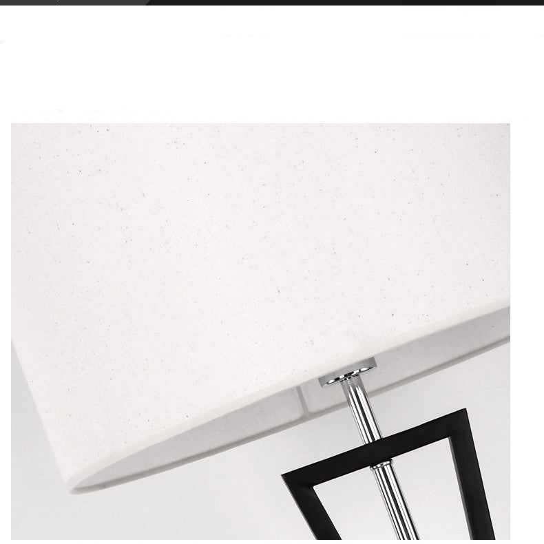 Detail of white fabric drum shade and finial