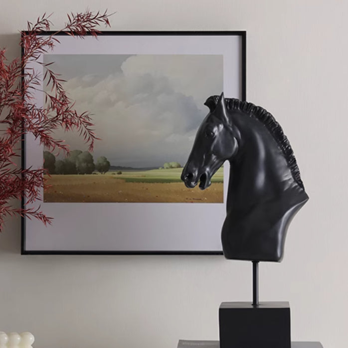 Side view of black horse head sculpture on console table