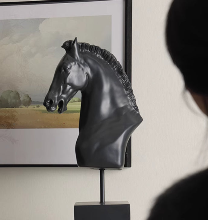 Profile view of black horse statue against art background
