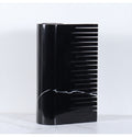 Close-up detail of black marble vase highlighting polished finish and architectural comb structure