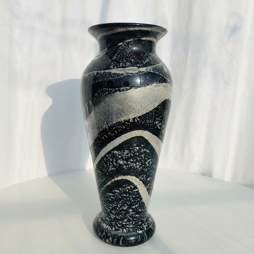 Front view of black and silver speckled glass vase