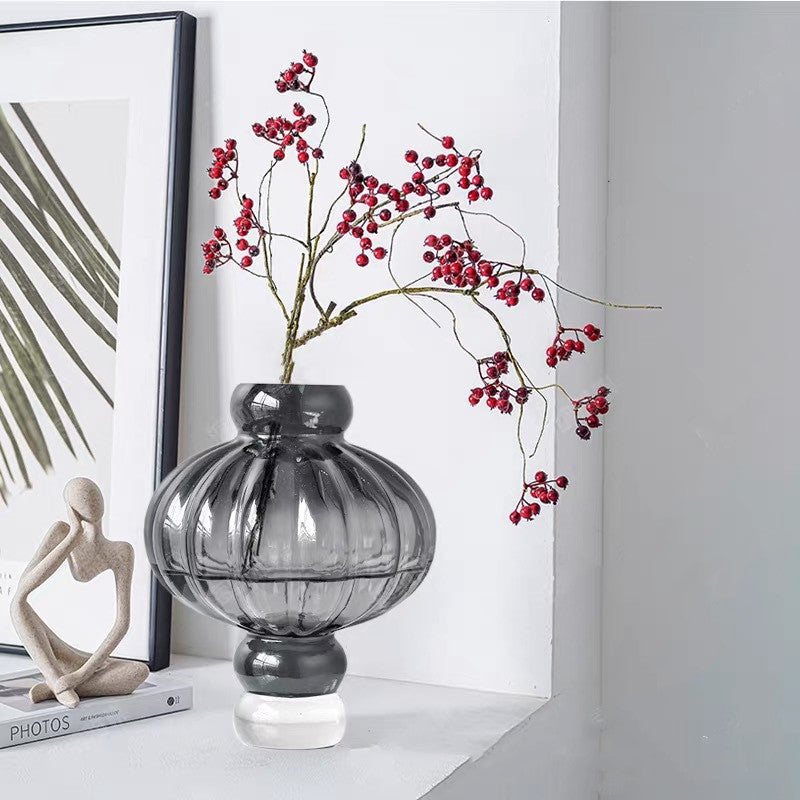 Front view of black smoked glass ribbed vase with red berries