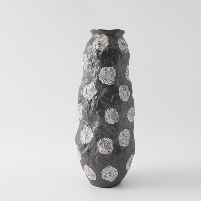 Large black ceramic vase with textured surface and white dots