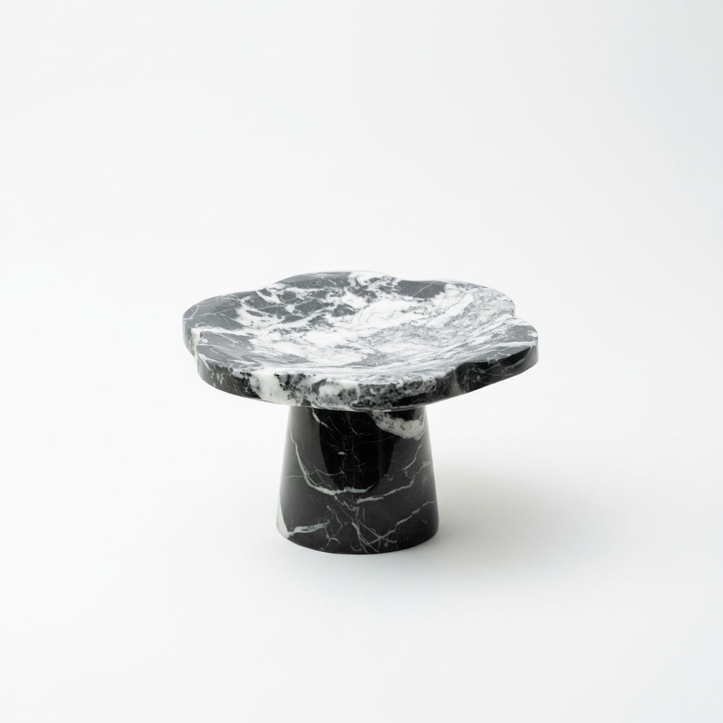 Black and white marble scalloped pedestal stand isolated on white background
