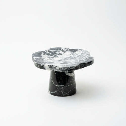 Black and white marble scalloped pedestal stand isolated on white background