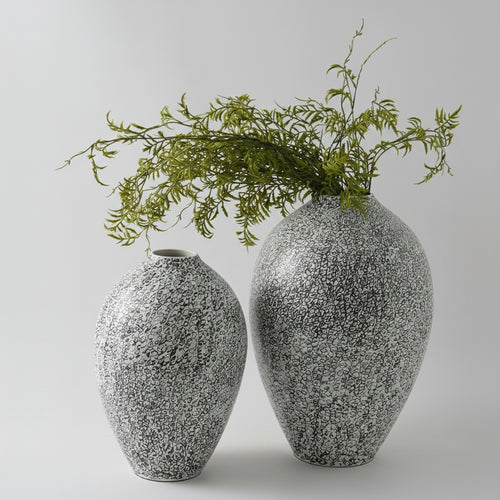 Black and white patterned ceramic ovoid vase with greenery