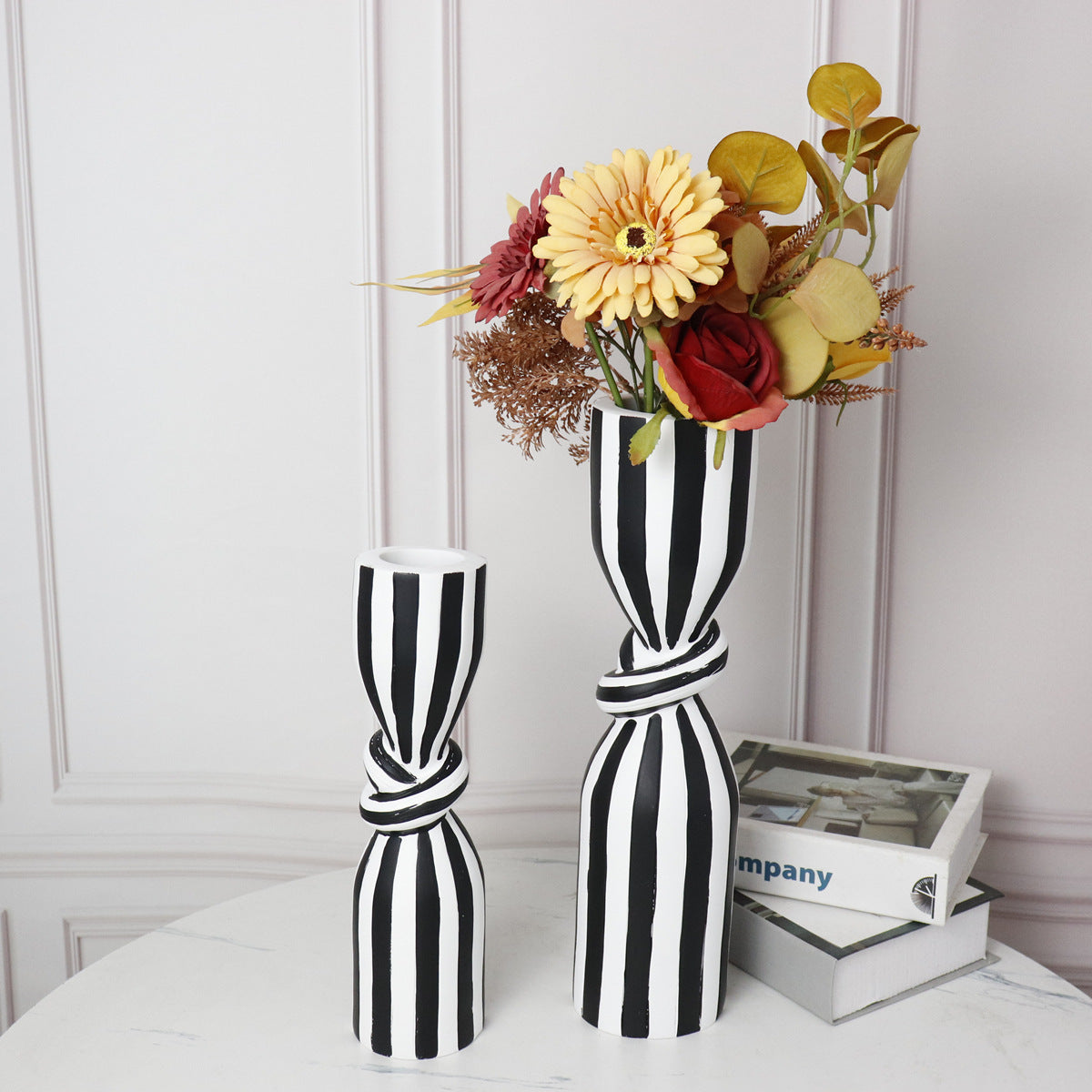 Black and white striped resin vase with flowers