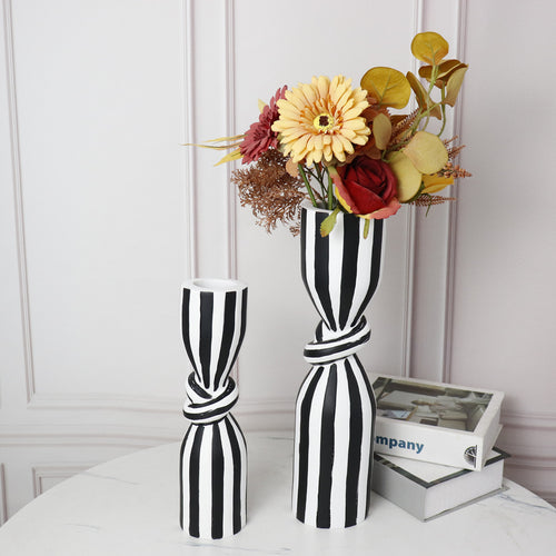 Black and white striped resin vase with flowers