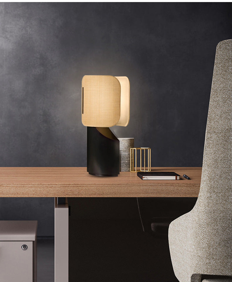 Angled view of sculptural table lamp on wooden desk