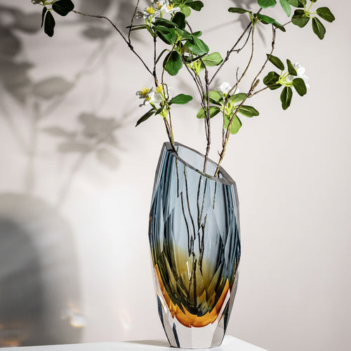 Side view of geometric gradient glass vase with flowers