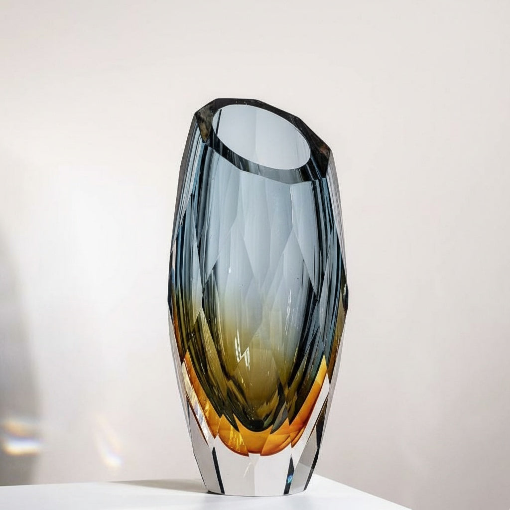 Close up of faceted blue and amber glass vase empty