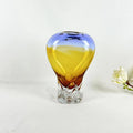Blue and amber gradient glass vase with rounded body and sculpted clear base