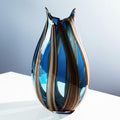 Front view of blue and amber striped art glass vase