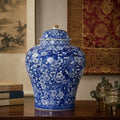 Blue and white porcelain ginger jar displayed on a wooden desk with books