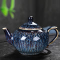 Full side profile of the blue artisanal glaze rounded ceramic teapot