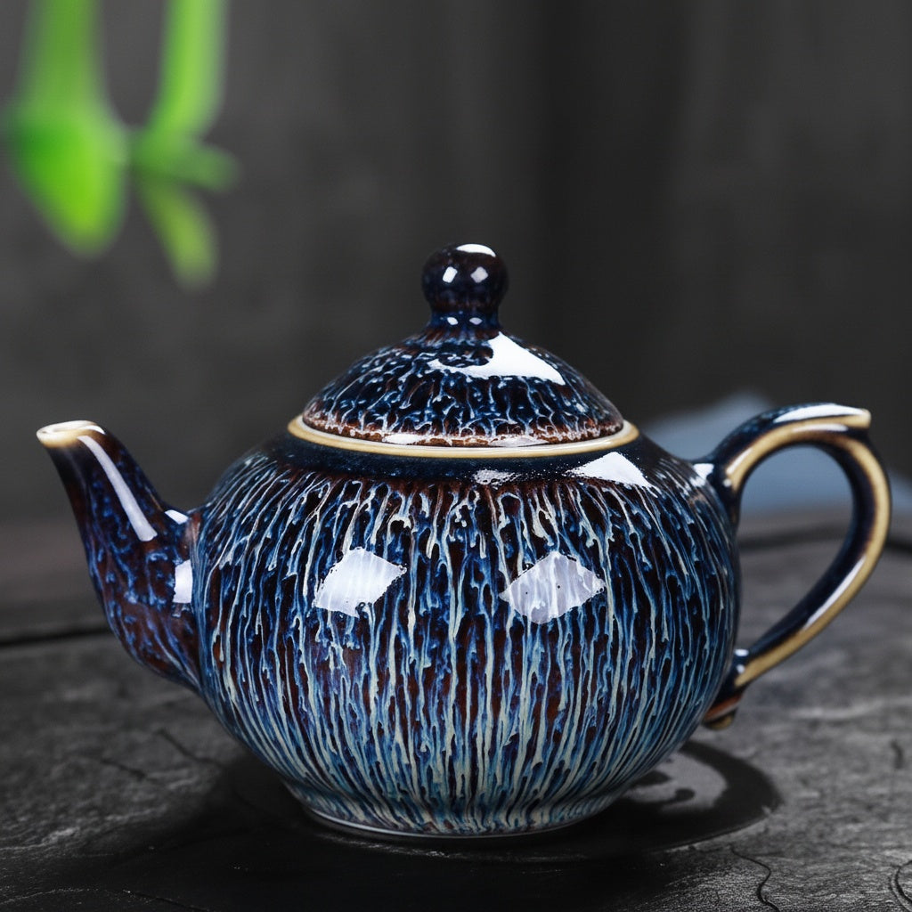 Full side profile of the blue artisanal glaze rounded ceramic teapot