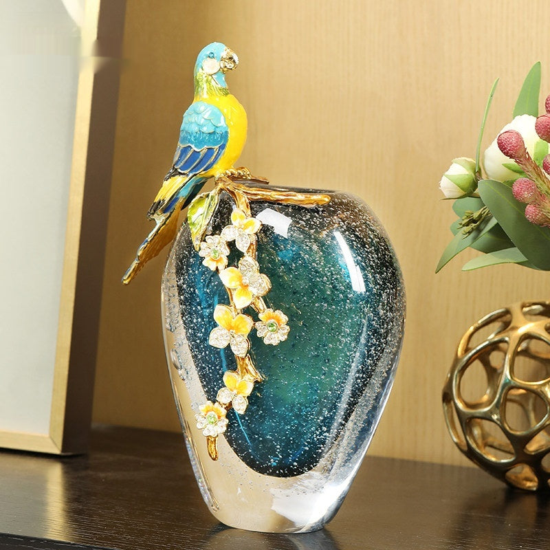 Front view of blue bubble glass vase with enamelled parrot