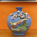 Front view of blue ceramic vase with pheasant relief