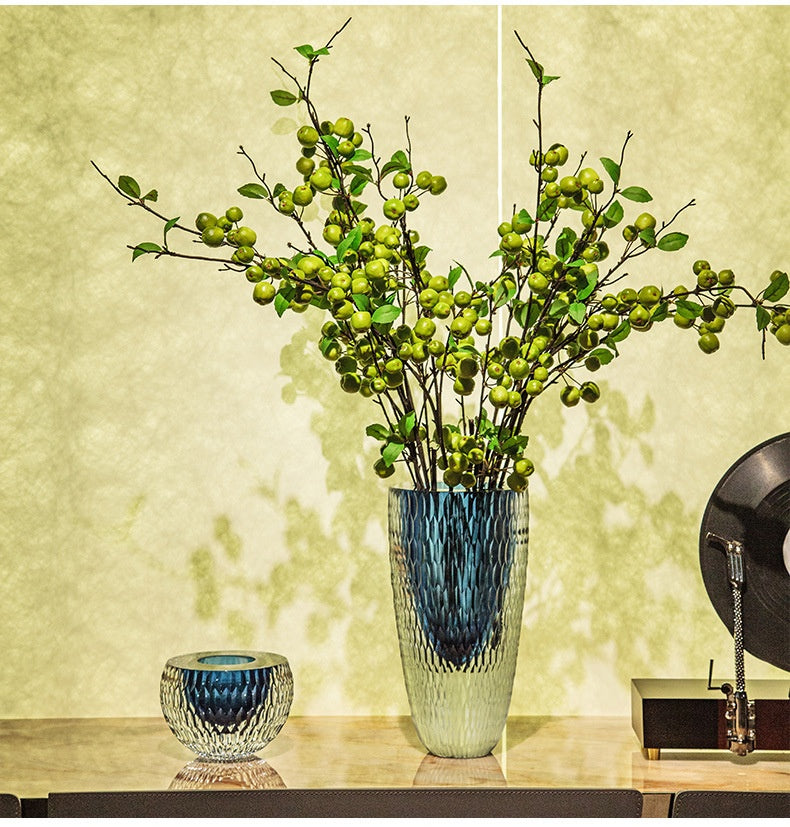 Tall and short geometric blue glass vases on console table