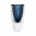 Close up of tall blue geometric glass vase