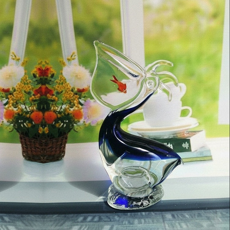 Symmetrical view of two glass pelican sculptures facing away