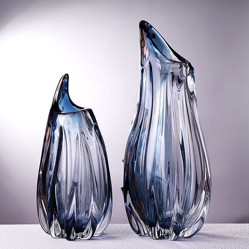 Two blue and copper crystal vases standing together