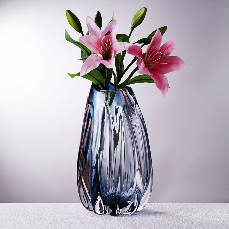 Medium blue crystal vase with pink lilies