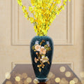 Front view of blue crackle vase with yellow flowers