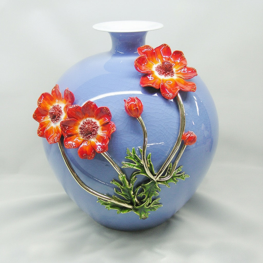 Front view of blue crackle glaze vase with sculpted orange flowers