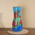 Front view of blue floral enameled vase with red roses
