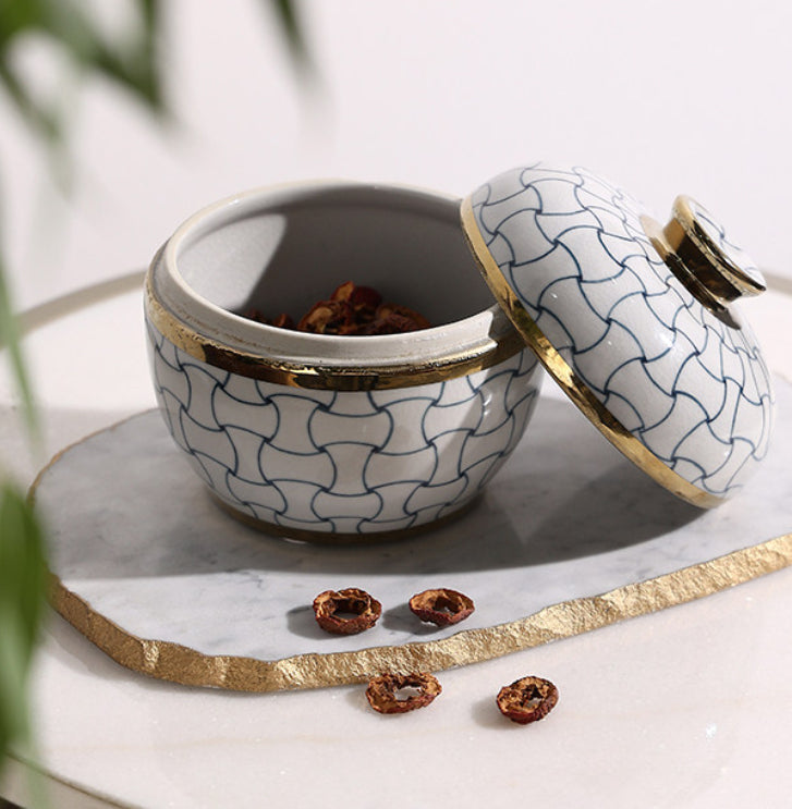 Ceramic jar with lid leaning against side